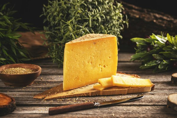What are the precise temperature and humidity levels needed for aging cheeses in a restaurant's kitchen?